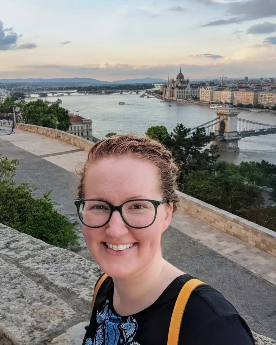Mairéad smiling on a terrace above the Danube in Budapest