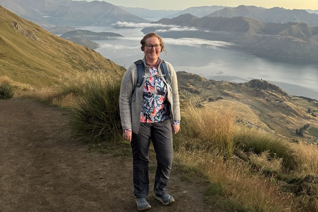 Mairéad on a mountain trail above Lake Wanaka in New Zealand at sunrise